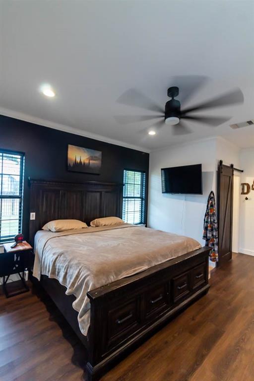 10800 Estate Lane Terrell, TX 75161 - Photo 11 of 30 a bedroom with a bed and a large mirror