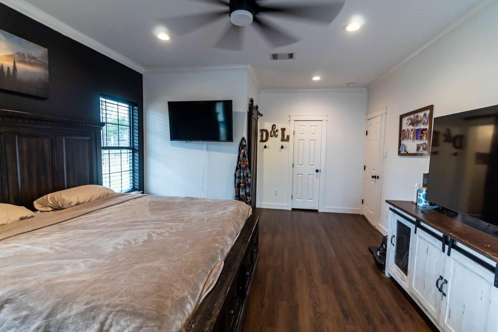 10800 Estate Lane Terrell, TX 75161 - Photo 12 of 30 a bedroom with a bed and a flat screen tv