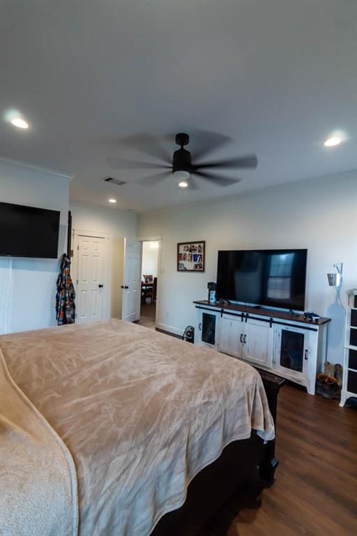 10800 Estate Lane Terrell, TX 75161 - Photo 13 of 30 a bedroom with a bed and a flat screen tv