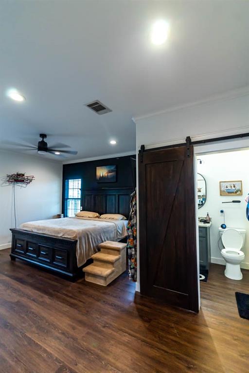 10800 Estate Lane Terrell, TX 75161 - Photo 15 of 30 a spacious bedroom with a bed and a refrigerator