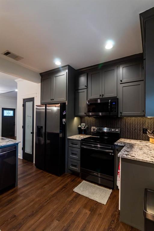 10800 Estate Lane Terrell, TX 75161 - Photo 27 of 30 a kitchen with stainless steel appliances granite countertop a refrigerator and a stove