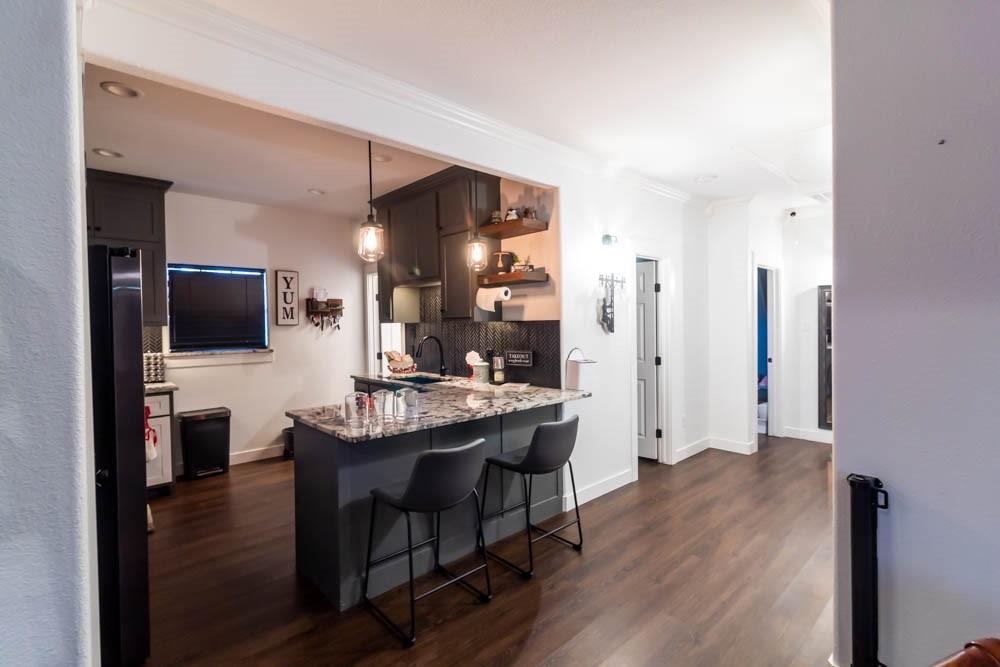 10800 Estate Lane Terrell, TX 75161 - Photo 28 of 30 a view of a kitchen area with furniture and wooden floor