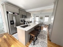 53 A Street Hull, MA 02045 - Photo 6 of 19 a kitchen with a sink a refrigerator a stove a washer and dryer