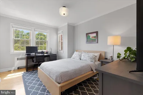 a bedroom with a bed and a table in it