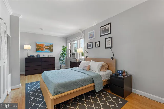 a bedroom with a bed and a dresser