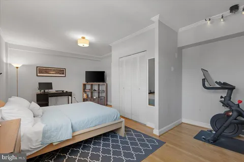 a bedroom with furniture and a flat screen tv