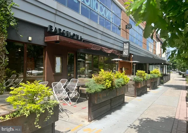 a view of a cafe with a table and chairs under an umbrella