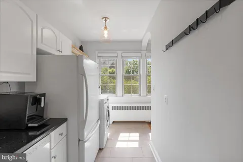 a kitchen with a window a sink and a refrigerator