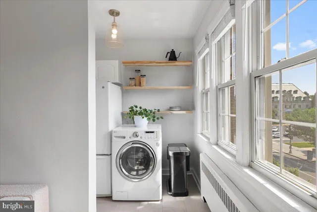 a utility room with sink dryer and washer