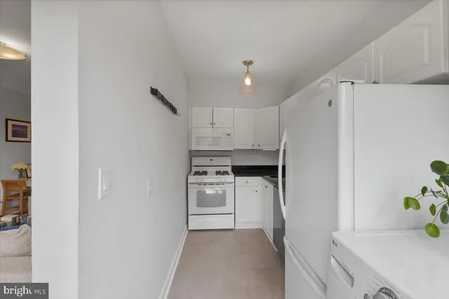 a kitchen with a cabinets and refrigerator