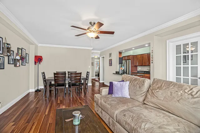 a living room with furniture and a wooden floor