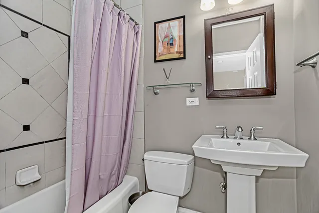 a bathroom with a toilet a sink and a mirror