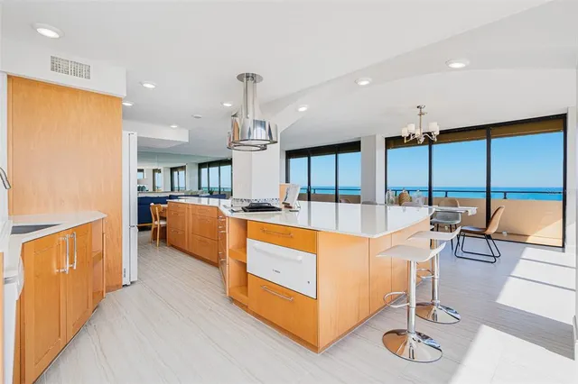 a large kitchen with stainless steel appliances kitchen island granite countertop a large kitchen a sink and a large window