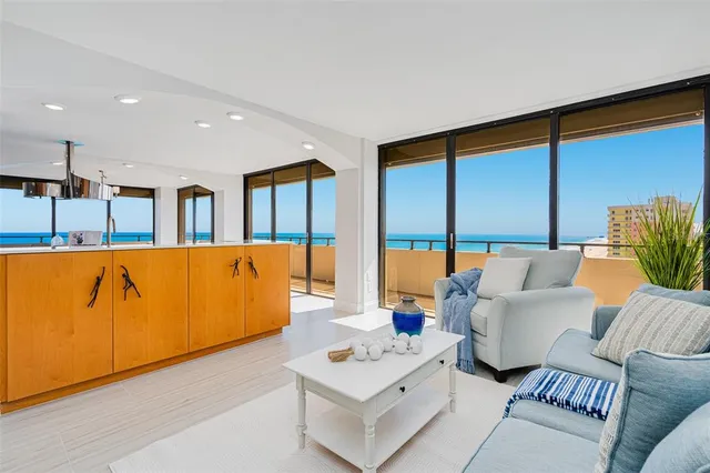 a living room with furniture city view and large windows