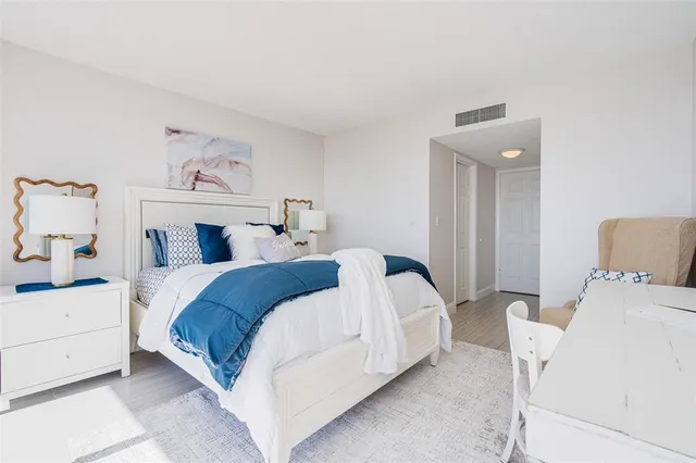 a bedroom with a bed and a painting on the wall