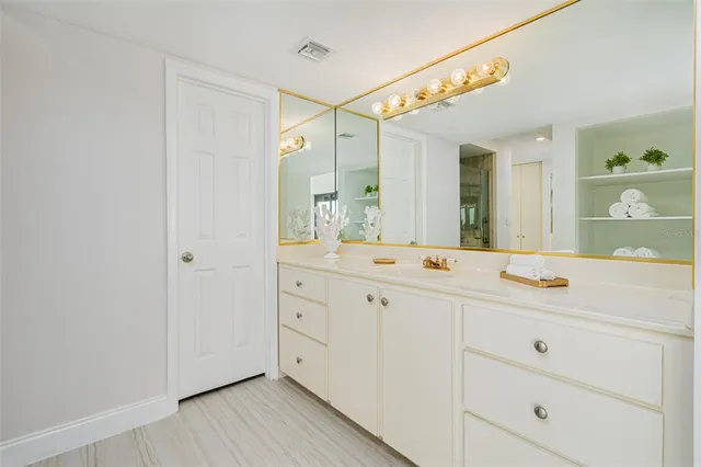 a bathroom with a shower a sink and a mirror