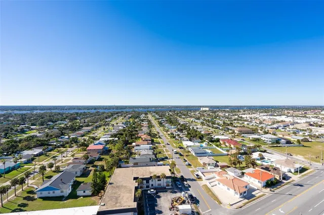 a view of a dining room with furniture and a potted plant