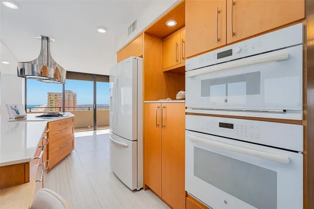 a kitchen with a refrigerator a stove and a cabinets
