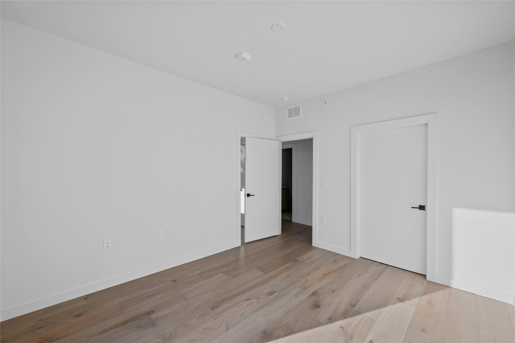 2209 South 1st Street, Unit 321 Austin, TX 78704 - Photo 16 of 40 a view of an empty room with wooden floor
