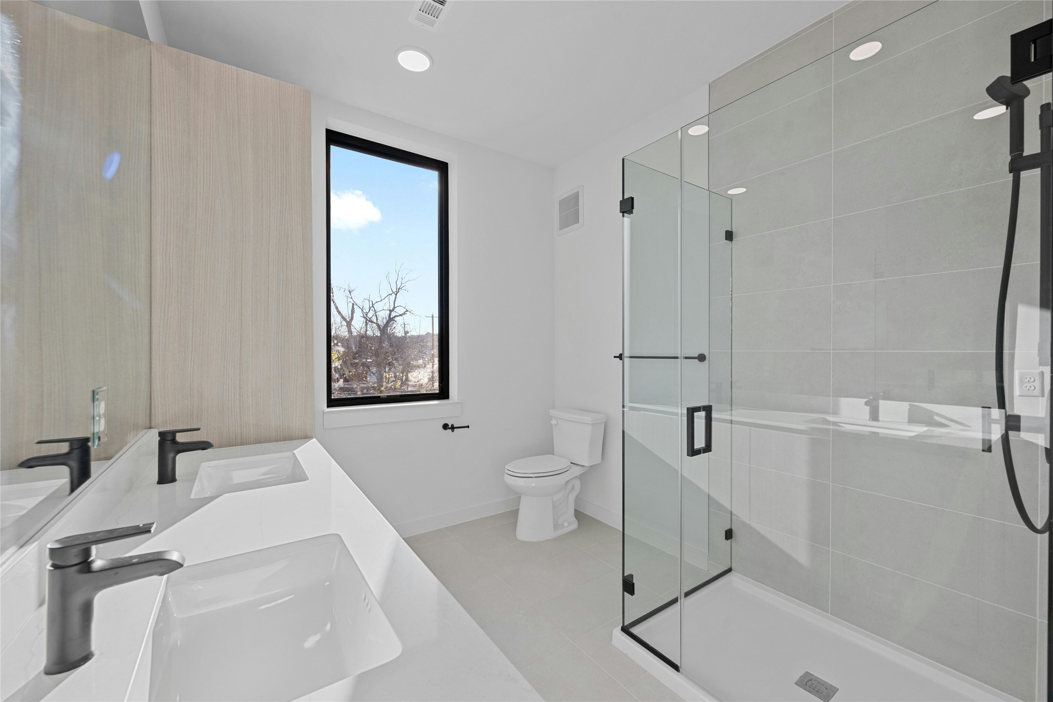 2209 South 1st Street, Unit 321 Austin, TX 78704 - Photo 17 of 40 a bathroom with a sink a toilet and shower