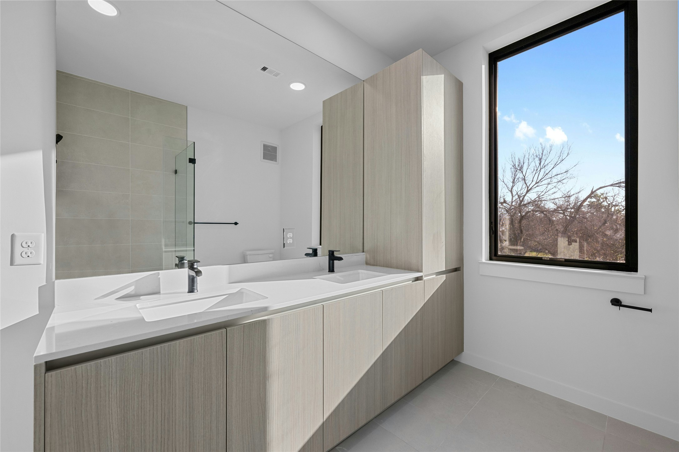 2209 South 1st Street, Unit 321 Austin, TX 78704 - Photo 18 of 40 a bathroom with a double vanity sink and mirror