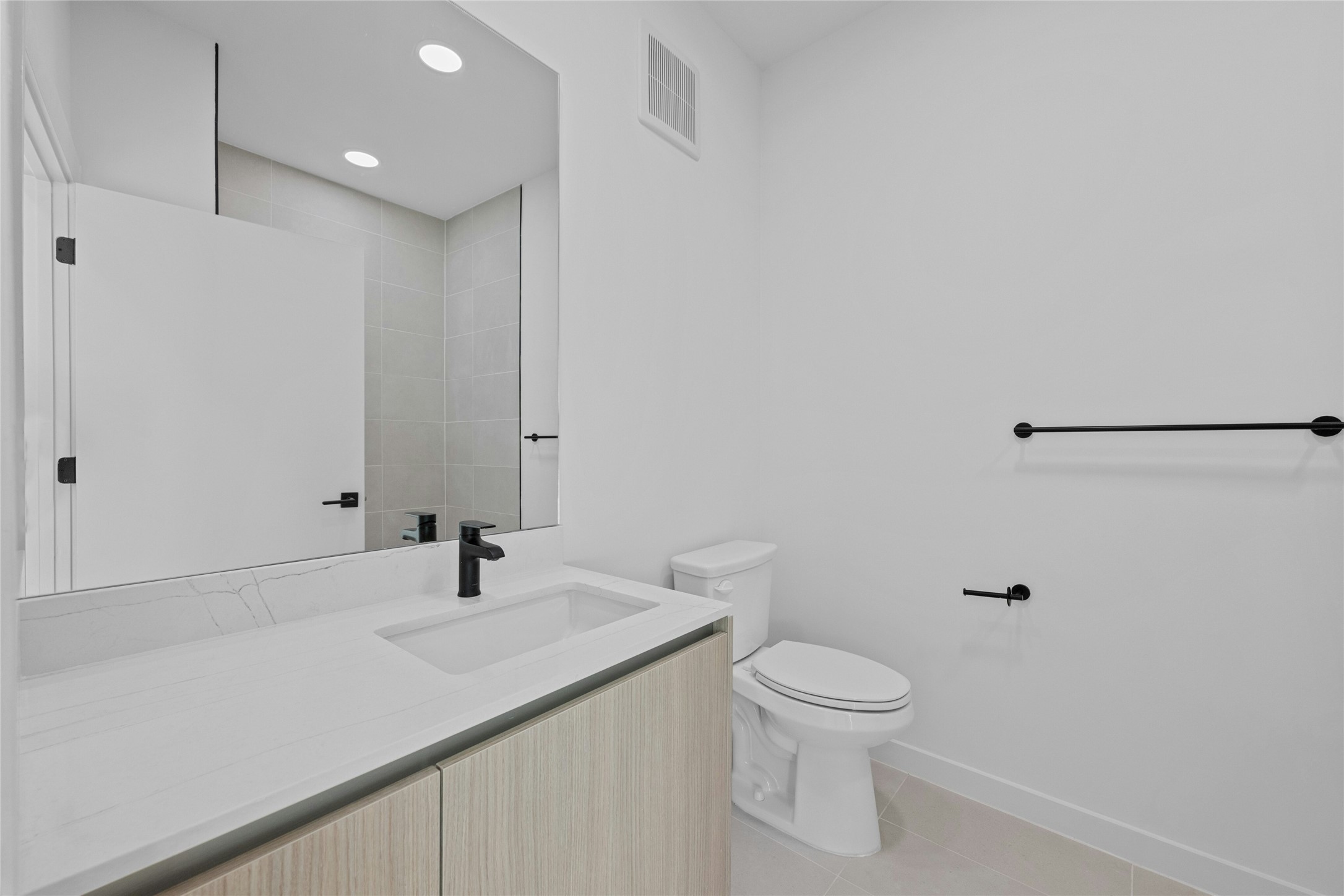 2209 South 1st Street, Unit 321 Austin, TX 78704 - Photo 23 of 40 a bathroom with a sink a toilet and shower
