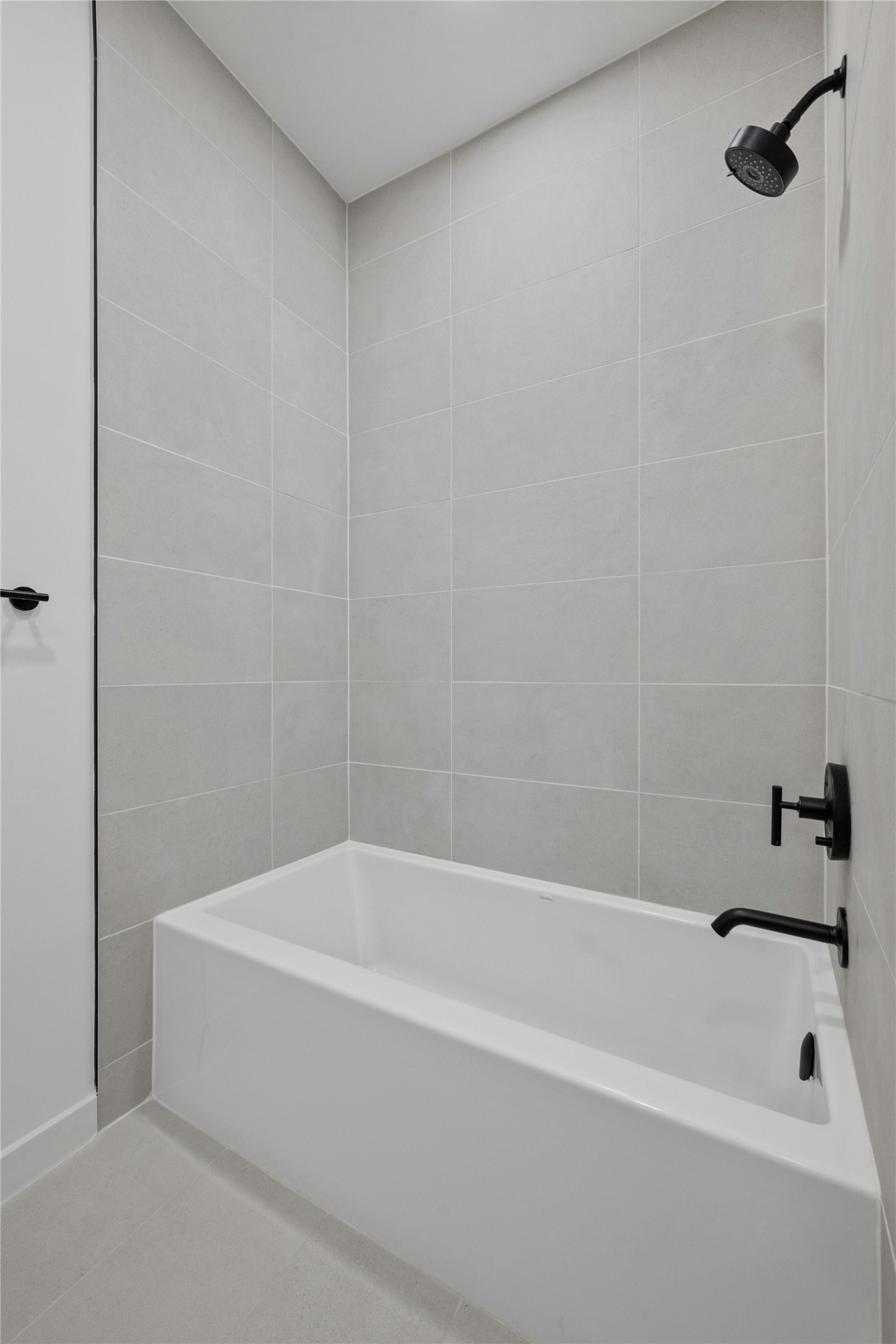 2209 South 1st Street, Unit 321 Austin, TX 78704 - Photo 24 of 40 a white bath tub sitting next to a white sink and vanity