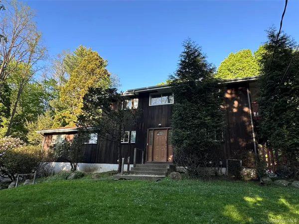 a house view with a sitting space and garden