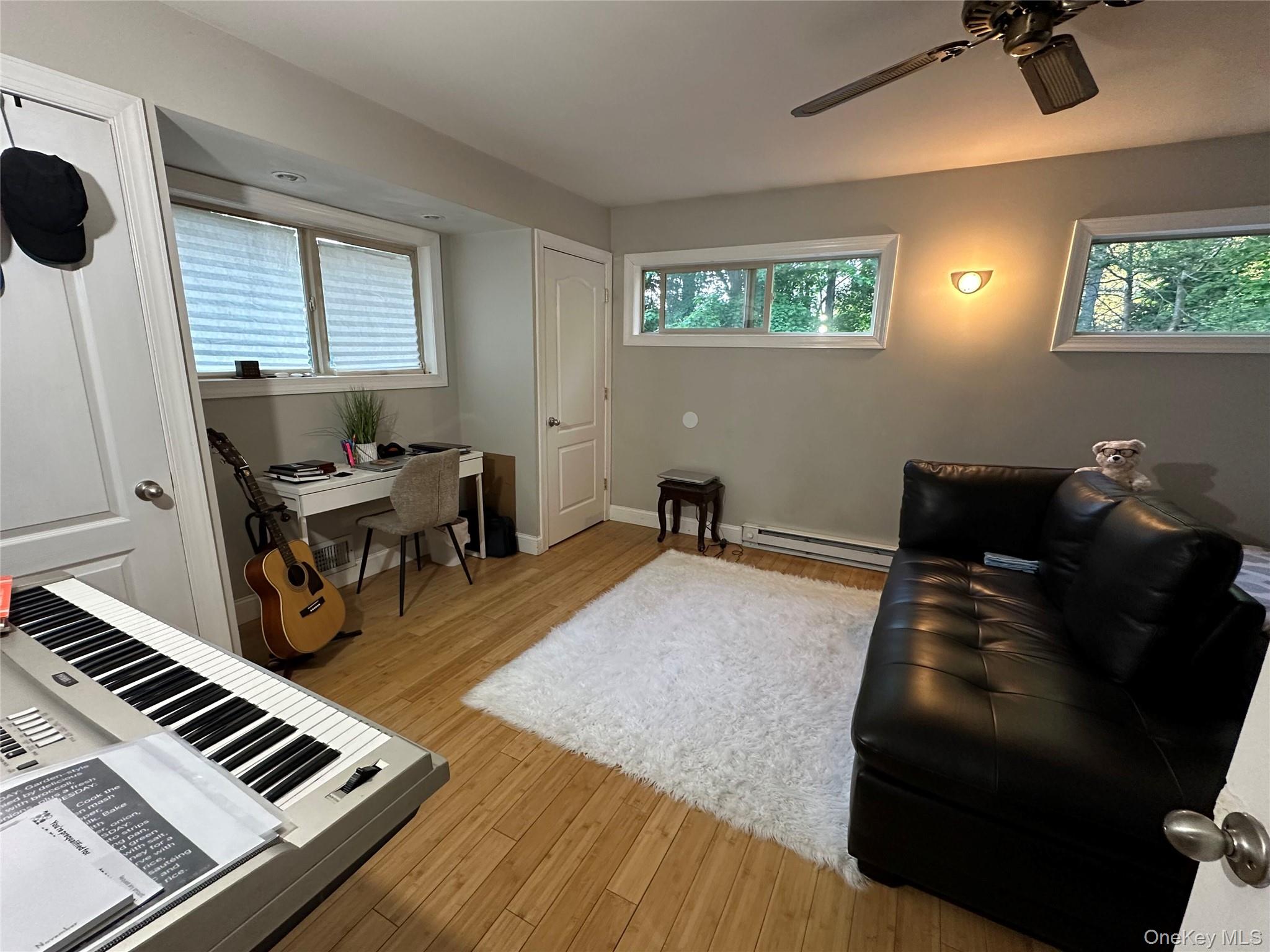 254 Hempstead Road Spring Valley, NY 10977 - Photo 5 of 7 a living room with furniture and a piano