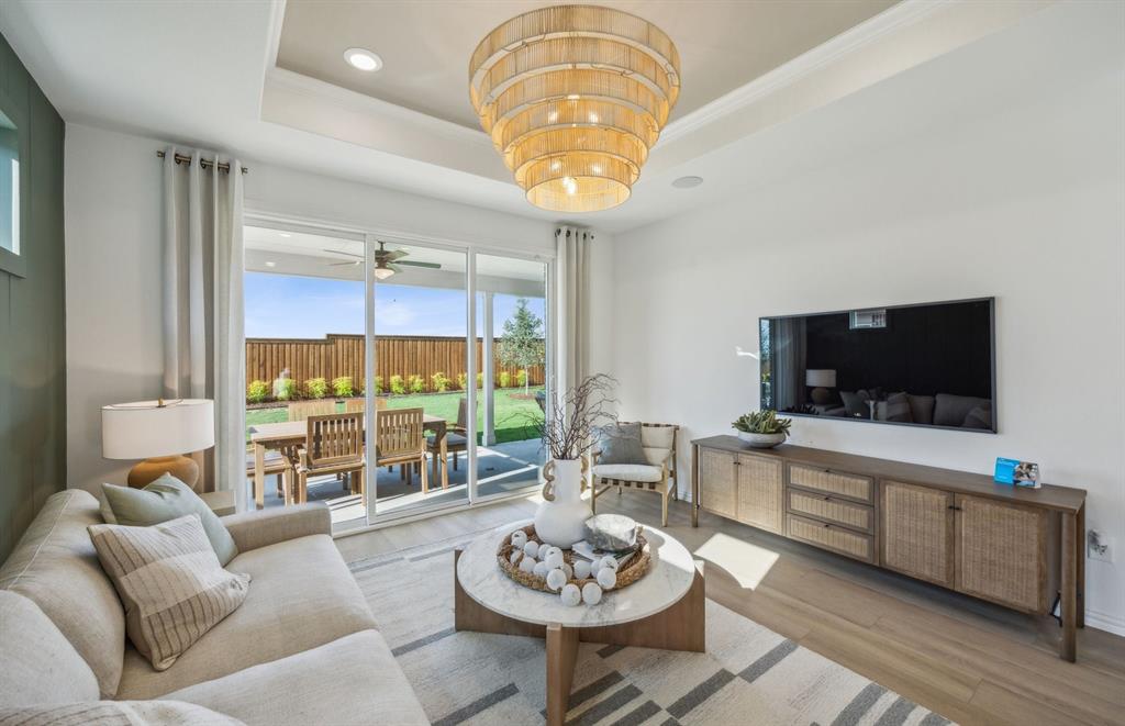 413 Snowbird Way McKinney, TX 75071 - Photo 7 of 14 Spacious gathering room with large windows *Model Representation*