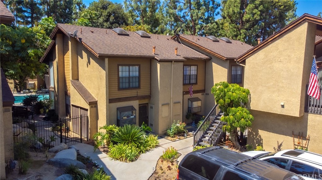 a brick house with potted plants in front of it