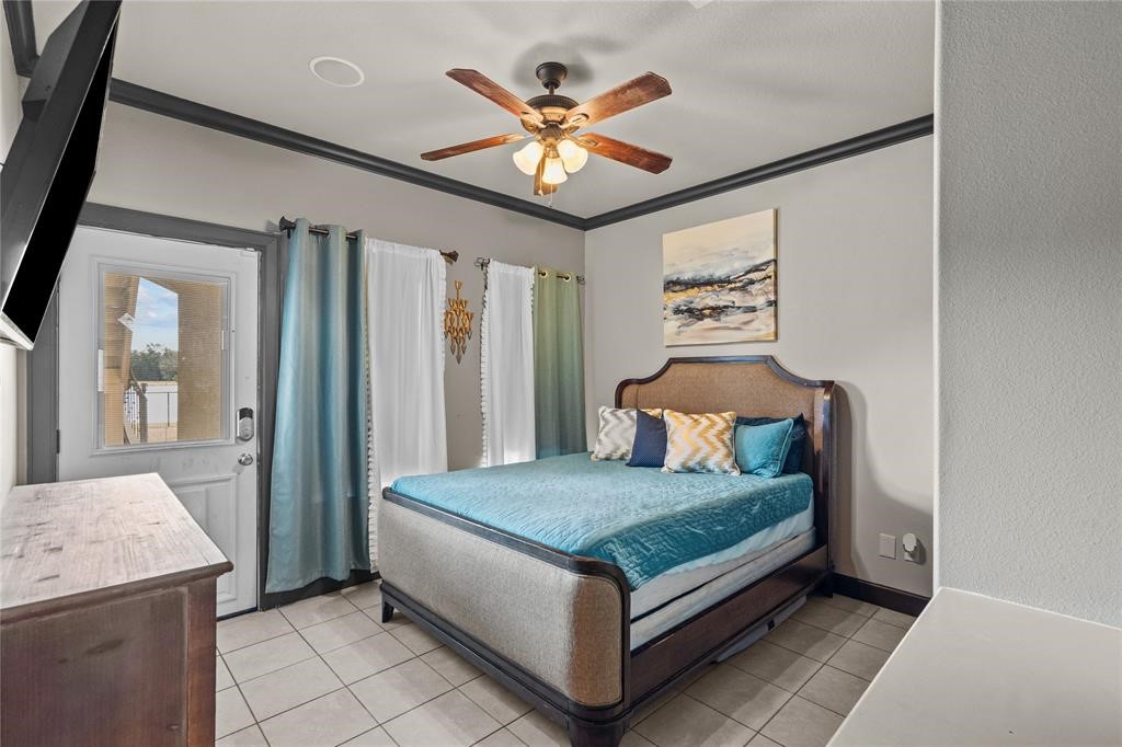 607 28th Street San Leon, TX 77539 - Photo 11 of 44 a bedroom with a bed and ceiling fan
