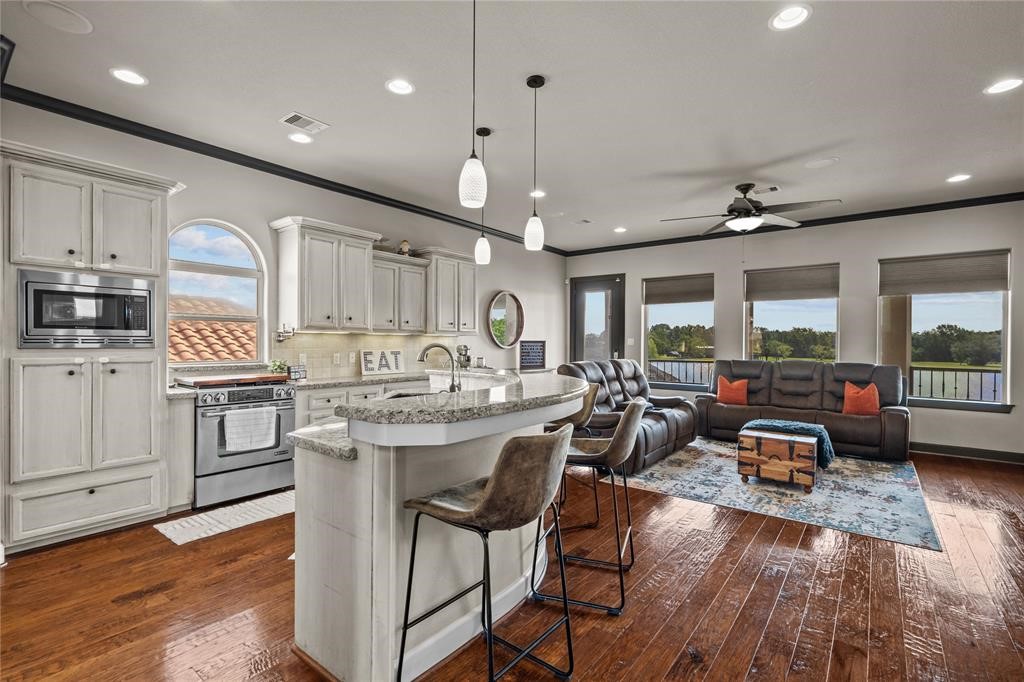 607 28th Street San Leon, TX 77539 - Photo 18 of 44 a kitchen with kitchen island a large counter and chairs