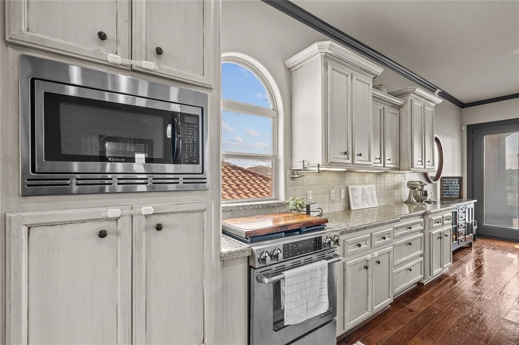 607 28th Street San Leon, TX 77539 - Photo 19 of 44 a kitchen with stainless steel appliances white cabinets and a stove top oven