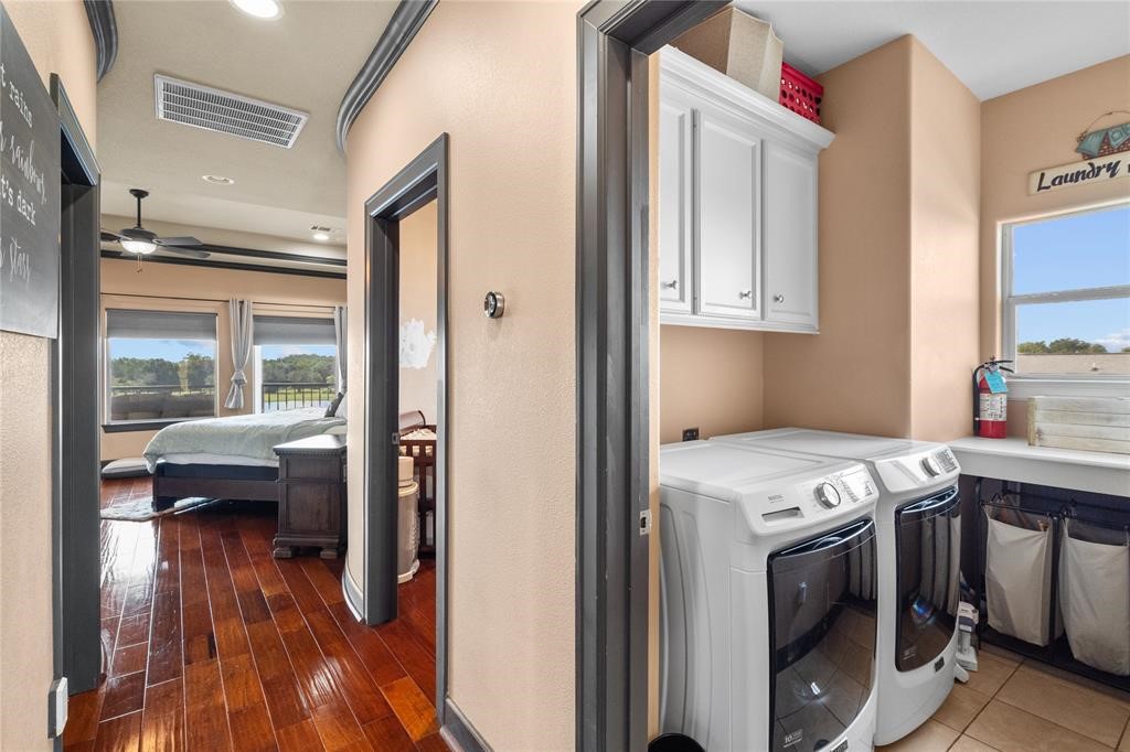 607 28th Street San Leon, TX 77539 - Photo 29 of 44 a utility room with wooden floor washer and dryer