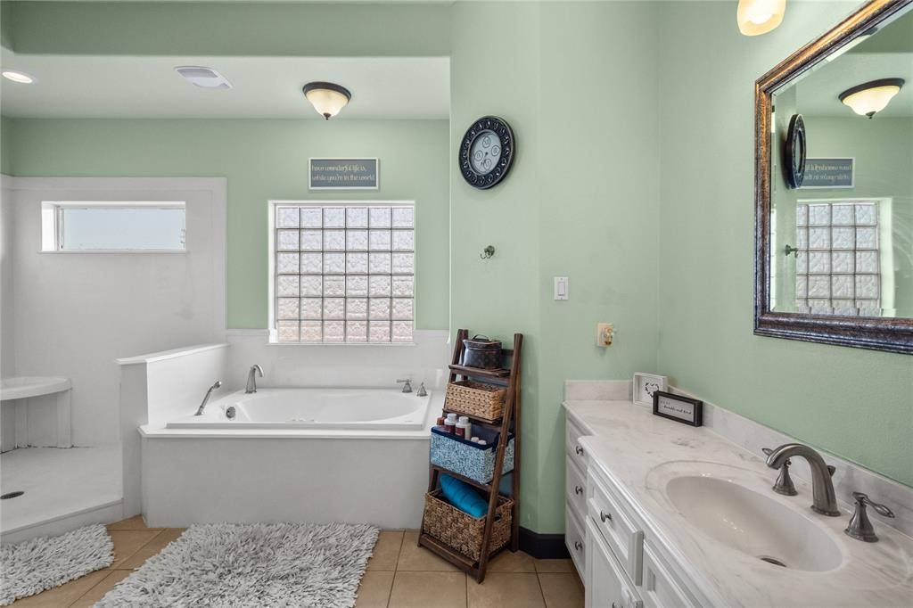 607 28th Street San Leon, TX 77539 - Photo 31 of 44 a bathroom with a bathtub a sink and a mirror