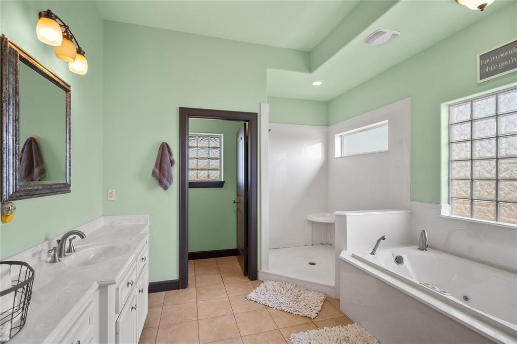607 28th Street San Leon, TX 77539 - Photo 32 of 44 a spacious bathroom with a tub sink and mirror
