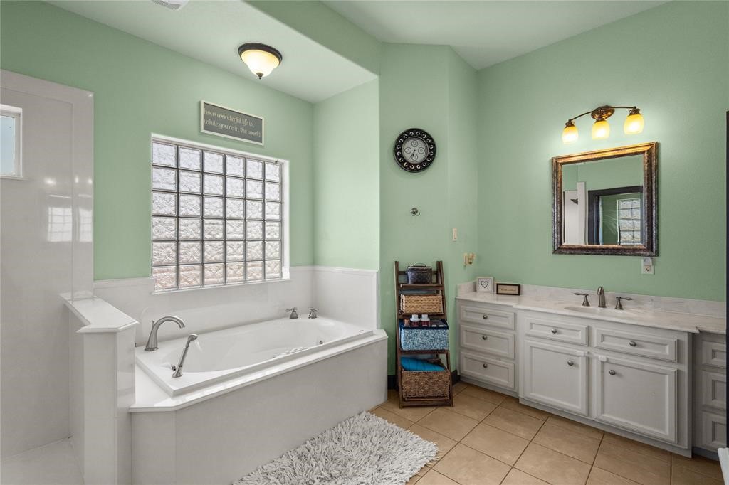 607 28th Street San Leon, TX 77539 - Photo 34 of 44 a bathroom with a tub sink and mirror