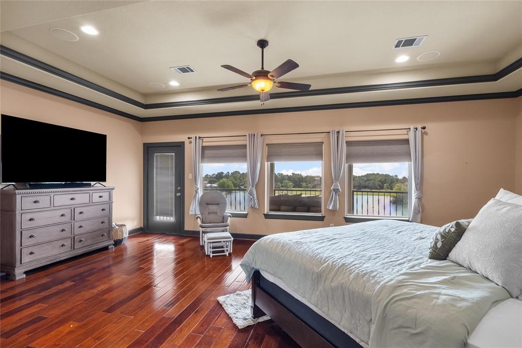 607 28th Street San Leon, TX 77539 - Photo 38 of 44 a bedroom with a bed and a flat screen tv on dresser