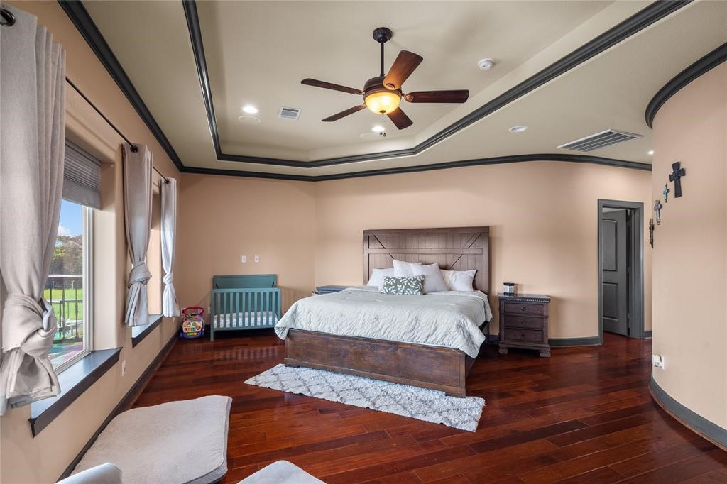 607 28th Street San Leon, TX 77539 - Photo 40 of 44 a bedroom with a large bed and a chandelier