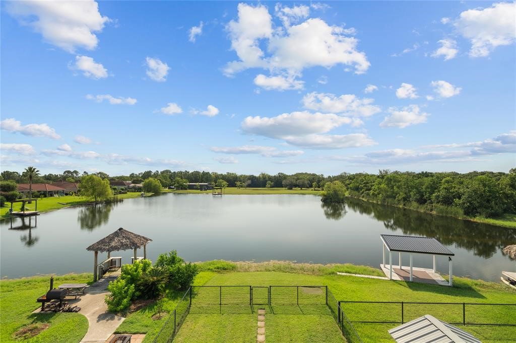 607 28th Street San Leon, TX 77539 - Photo 43 of 44 a view of a lake with table and chairs next to an ocean