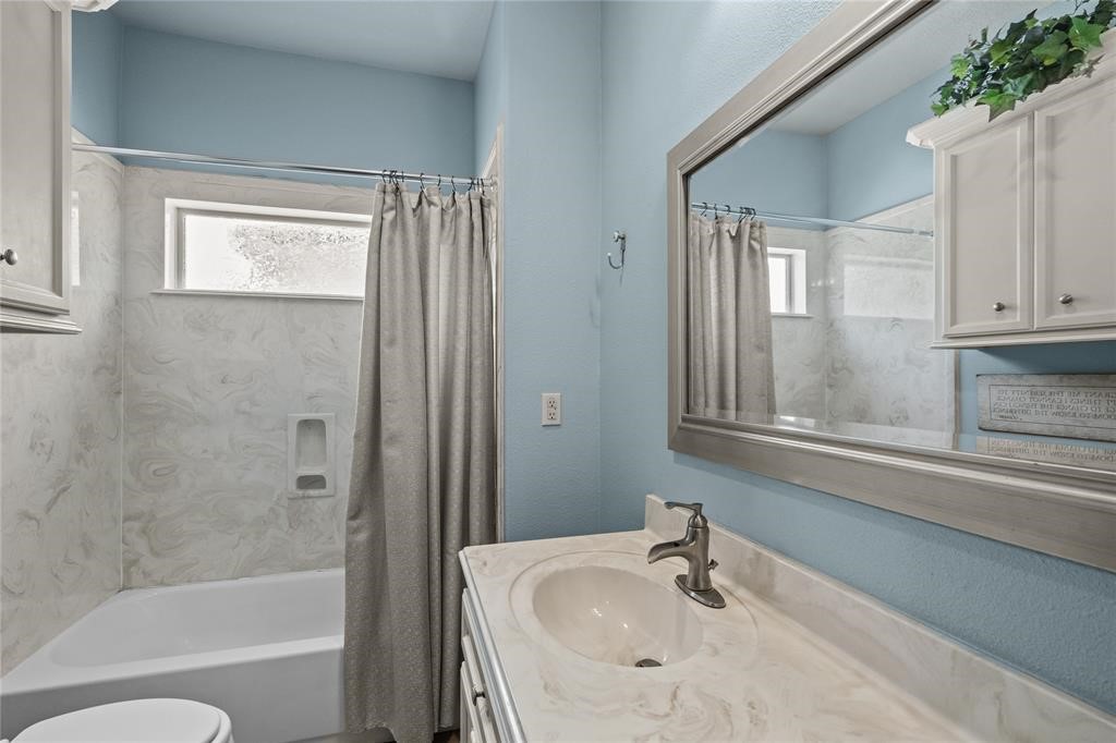 607 28th Street San Leon, TX 77539 - Photo 10 of 44 a bathroom with a granite countertop bathtub shower sink and mirror