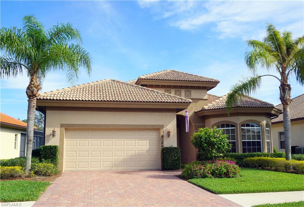 6189 Bunker Place Naples, FL 34113 - Photo 1 of 25 a front view of a house with a garden