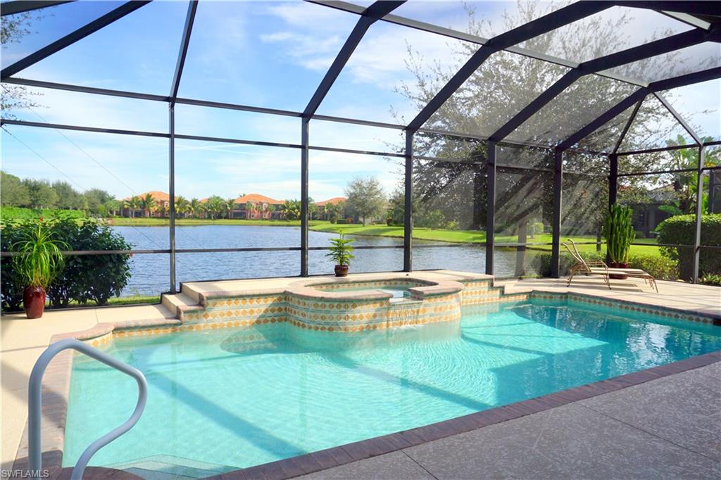 6189 Bunker Place Naples, FL 34113 - Photo 3 of 25 a view of a swimming pool with a patio
