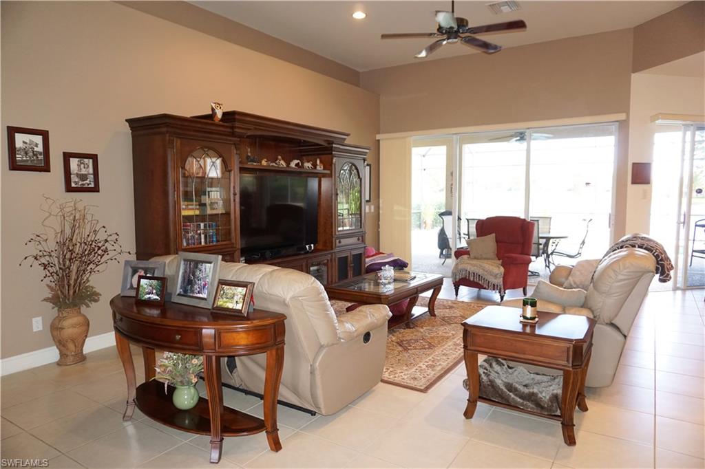 6189 Bunker Place Naples, FL 34113 - Photo 5 of 25 a living room with furniture and a large window