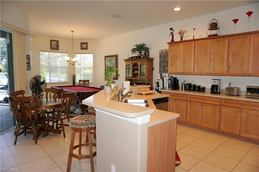 6189 Bunker Place Naples, FL 34113 - Photo 6 of 25 a kitchen with a sink counter top space and appliances