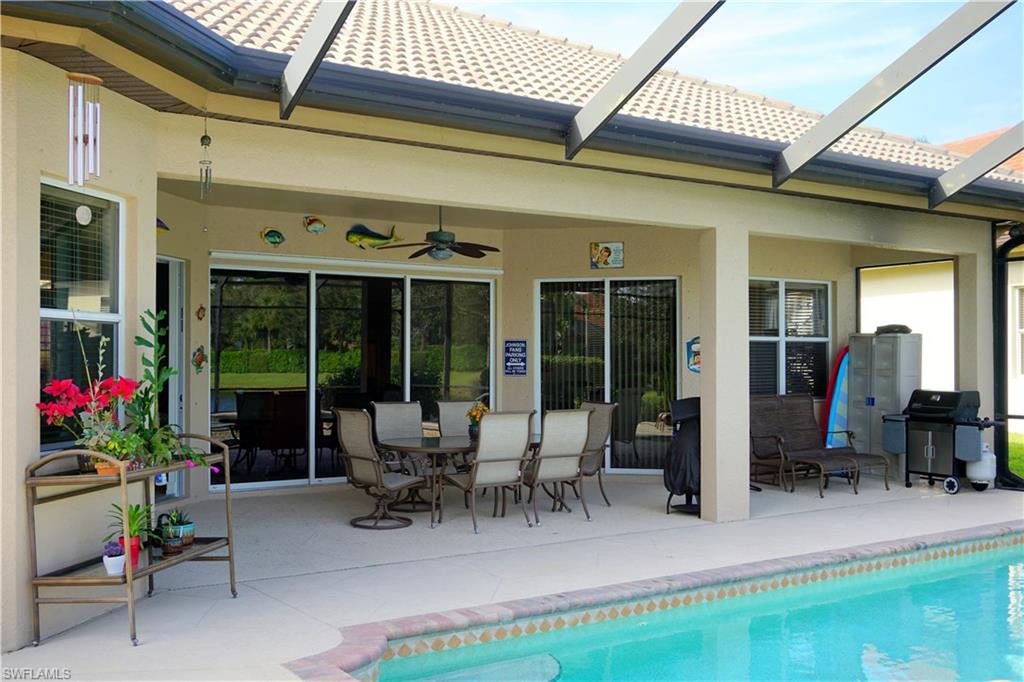 6189 Bunker Place Naples, FL 34113 - Photo 8 of 25 a view of a patio with table and chairs and potted plants