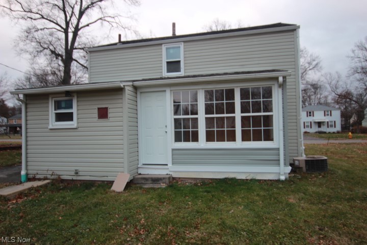 3606 Shelby Road Youngstown, OH 44511 - Photo 2 of 33 Back of house featuring a yard and central AC unit