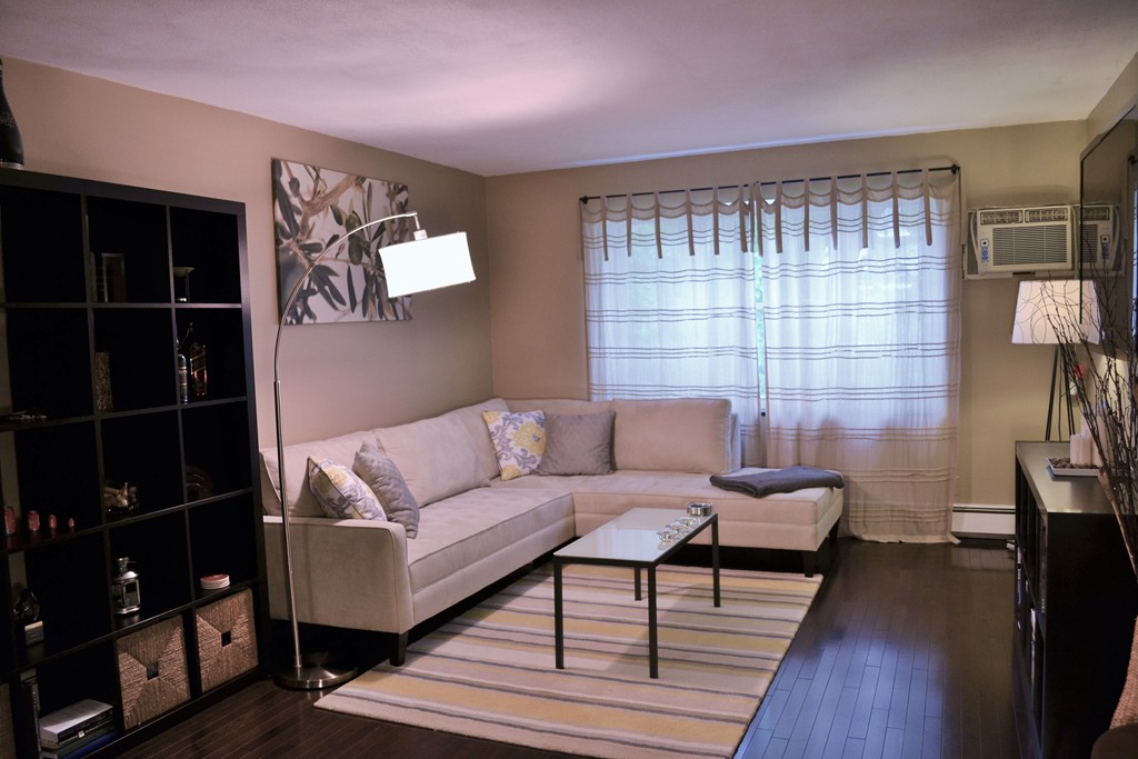 100 Summer Street, Unit 14 Watertown, MA 02472 - Photo 1 of 9 a living room with furniture and a flat screen tv