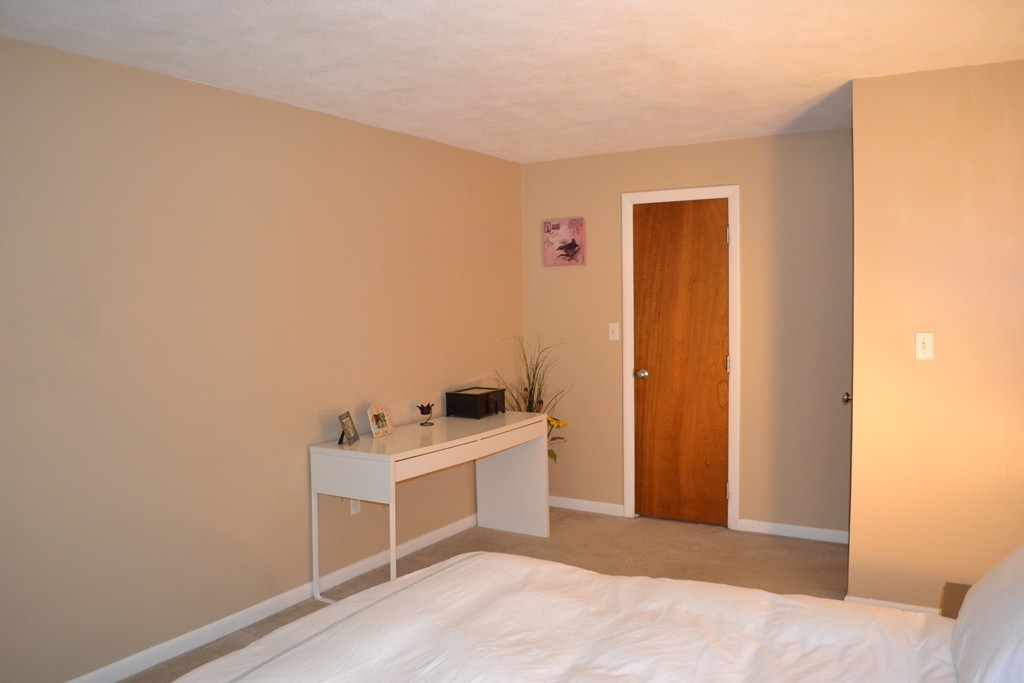 100 Summer Street, Unit 14 Watertown, MA 02472 - Photo 3 of 9 a room with a bed and a cabinets